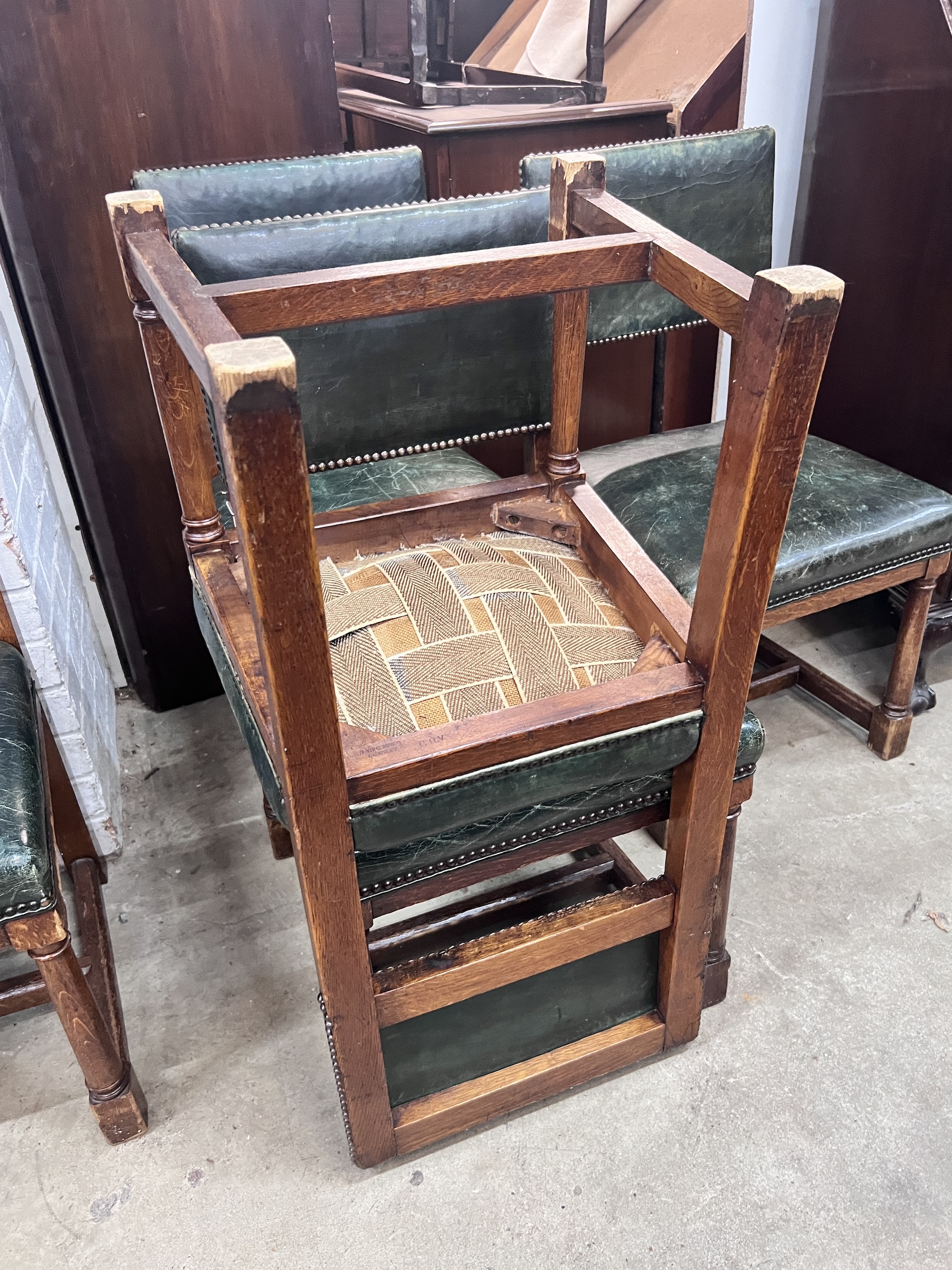 A set of five George VI oak and green leather 'House of Parliament' chairs by R & H Mines, Downley, width 46cm, depth 43cm, height 86cm